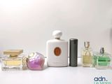 many different types of perfumes on a white table
