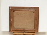 an old wooden easel with a brown canvas on top of it