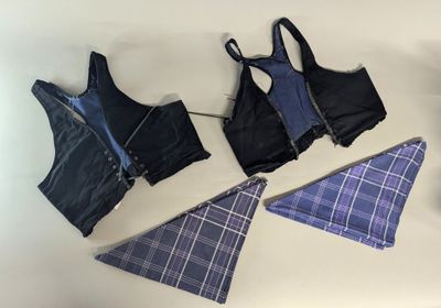 several pieces of clothing are laid out on a white surface