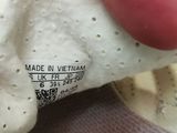 a hand holding a piece of paper that has been placed on a pair of shoes