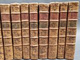 a set of six old books sitting on top of each other