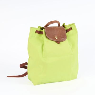 the backpack is green and brown with a brown handle