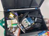 a black box filled with assorted items on the floor