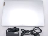 a white laptop with a power cord and a charger on it