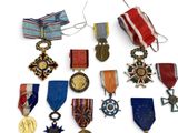 many medals and medals on display on a white surface