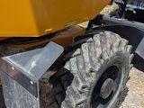 a tractor that is parked on the side of the road
