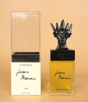 an image of a bottle of perfume next to a box of perfume