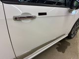 a close up of a door handle on a white car