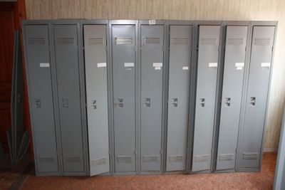 several metal lockers are lined up in a row in a room