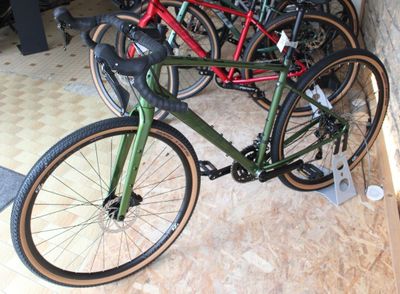 many bikes that are parked in a room together