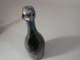a bottle of wine that has a face on it