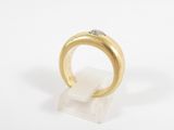 a close up of a gold ring with a diamond on top of it