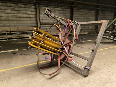 a pile of chairs and a chair on the floor in a warehouse