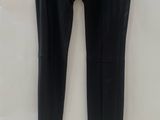 a pair of black leather pants hanging on a hanger