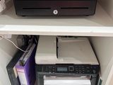 a printer that is sitting on top of a shelf