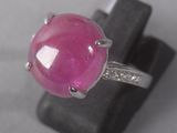 an image of a ring with a pink stone and diamonds on it