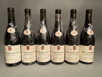 six bottles of wine are lined up in a row on a table
