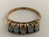 a close up of a gold ring with oplite stones on it