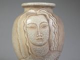 a white vase with a picture of a woman on it