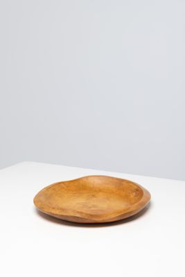 an empty wooden plate on a white table