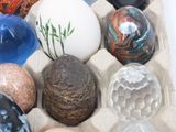 many different colored eggs in a carton on the table