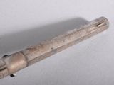 a small metal object on a table with a white background