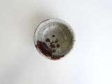 a small bowl that has a brown substance in it