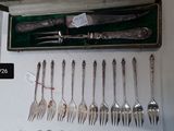 a lot of forks and spoons that are in a case