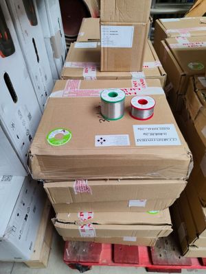 several boxes of spools are stacked on top of each other in a warehouse