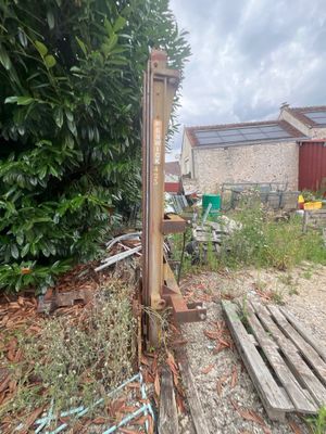 a wooden fence in the middle of a yard