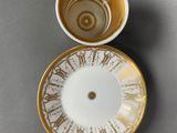 a coffee cup and saucer sitting on a table