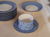 many plates and cups sitting on a table