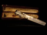 a silver pen sitting in a box on a table
