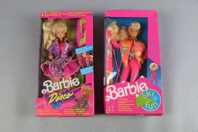 two barbie dolls are sitting in their boxes on a table
