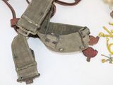 a pair of holsters and a pair of scissors on a table