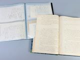 a book open on a table with papers on it
