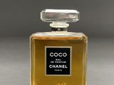 a close up of a bottle of perfume on a table