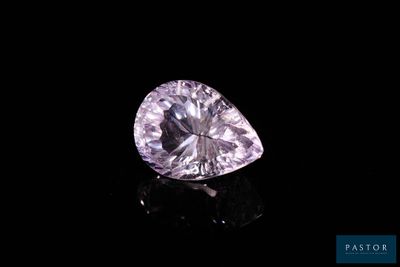 a heart shaped pink diamond on a black surface