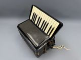 a close up of a black and white accordion sitting on top of a table