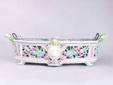 an image of a decorative planter with flowers on it