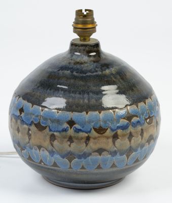 a blue and brown vase with a light on it
