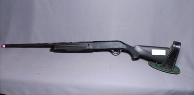 a shotgun that is sitting on top of a table
