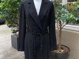 an image of a black coat on a mannequin stand