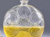 a glass bottle with a yellow liquid inside of it