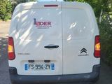 a white van that is parked on the side of the road