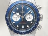 a close up of a watch with a blue face