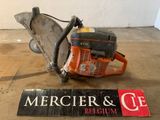 a chainsaw sitting on the floor next to a sign that says mercierr and ce belgium