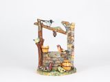a figurine of a well with birds on it