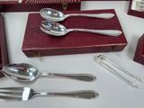 silverware on a white table with a red box