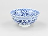 blue and white bowl with a design on the outside of the bowl